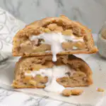 Coconut Ranger Cookies fresh from oven on rustic board