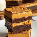 Close-up of Biscoff Cheesecake Brownie with cookie crust, brownie, and cheesecake layers