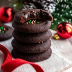 Chocolate thumbprint cookie with shiny ganache and sprinkles.